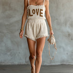 ElevenOra Chic Elegant Cream White Spaghetti-Strap Square-Neck Sleeveless Letter Jacquard Fringe Detail Loose-Fit Knit Romper